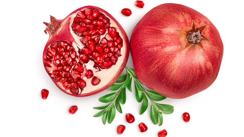 Pomegranate with seeds on white background