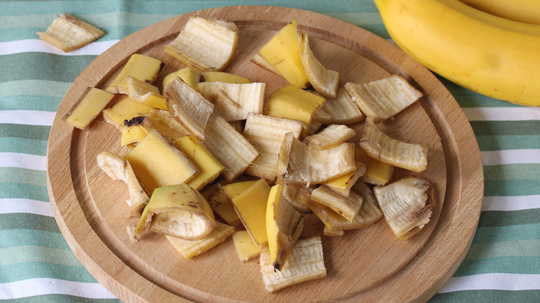 Chopped up banana peels on wooden board