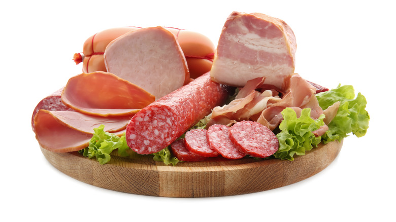 A selection of deli meats on a wooden board