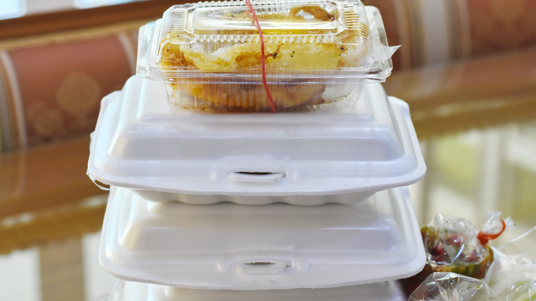 Styrofoam boxes and plastic container stacked together