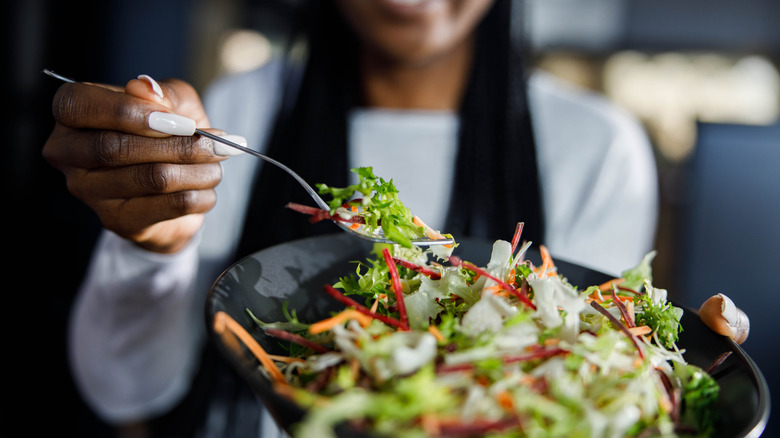 person eating salad