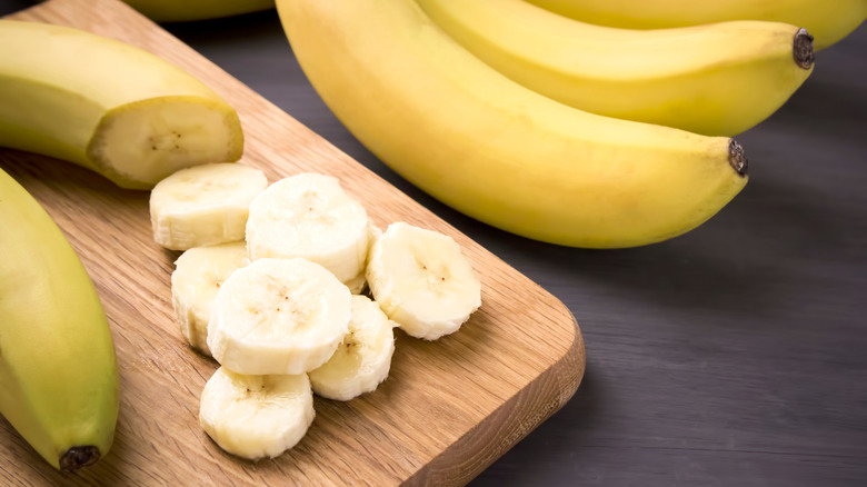 Sliced bananas on a wooden cutting board