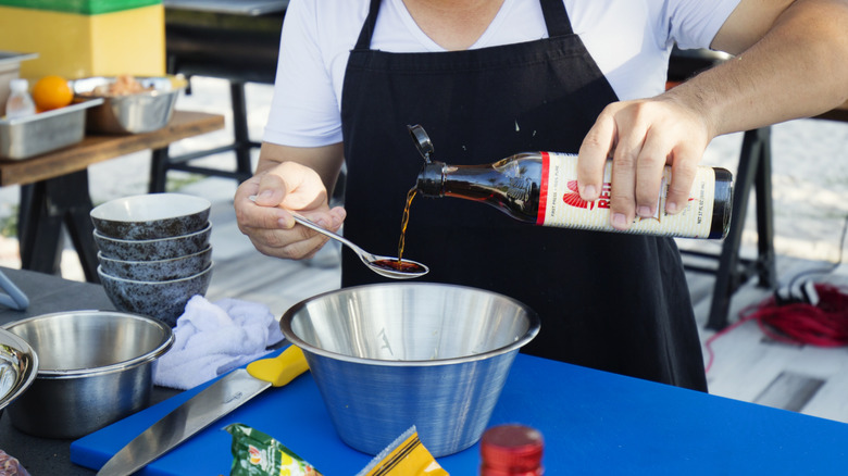 Adding fish sauce to a dish