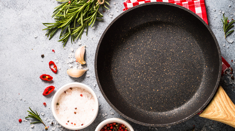 frying pan by spices and herbs
