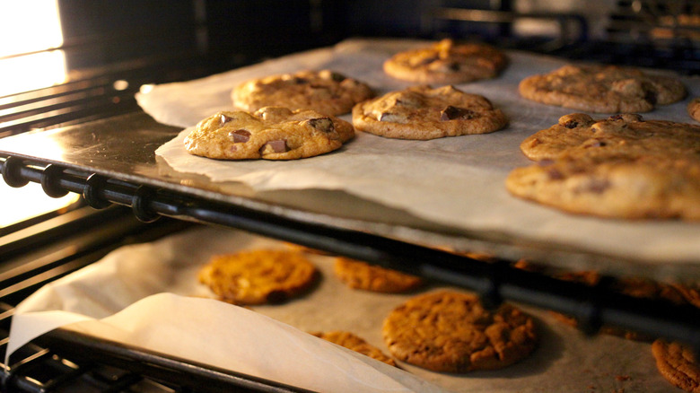two baking sheets of cookies in oven