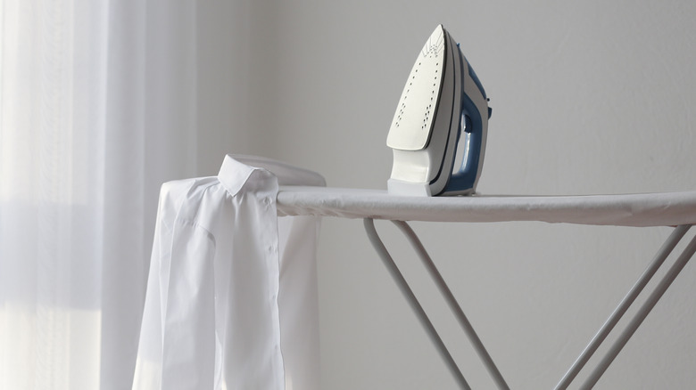 Shirt and iron sitting on ironing board