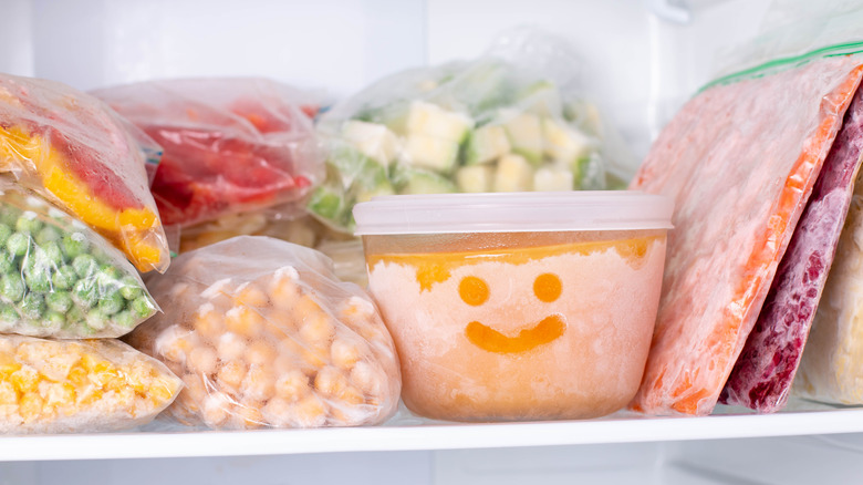 A freezer filled with frozen items.