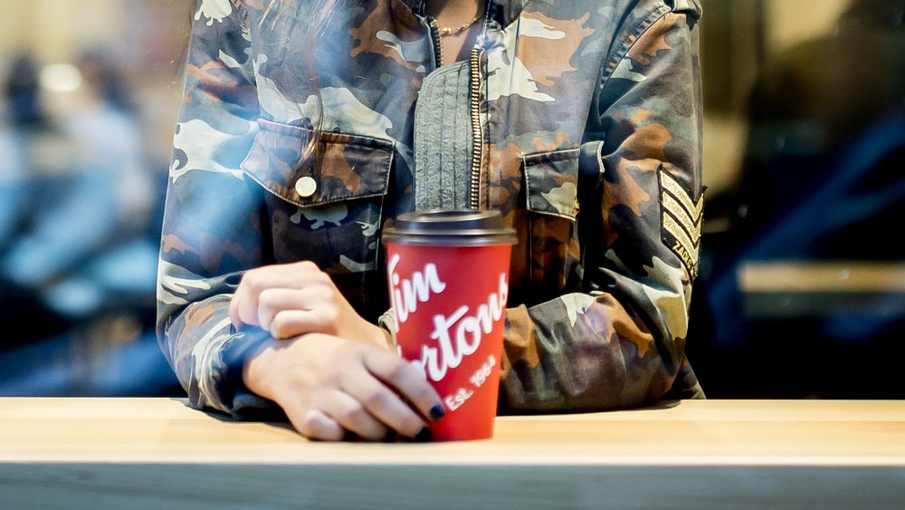 Person drinking Tim Hortons coffee