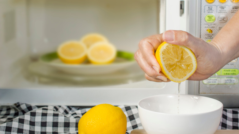 Woman squeezing half a lemon 
