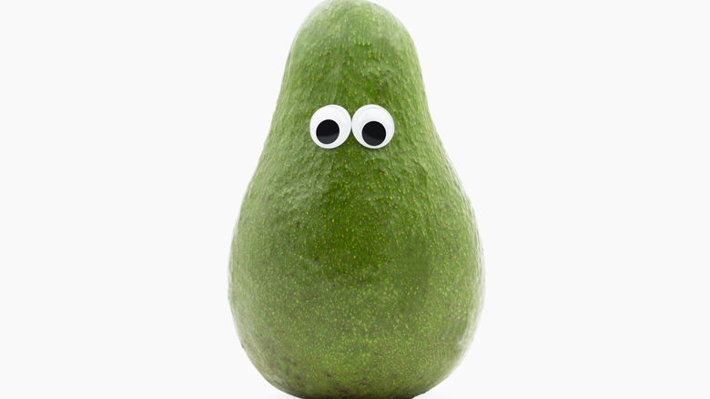 An avocado sporting googly eyes
