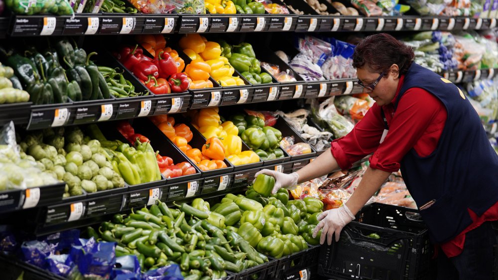 A Walmart employee stocks shelves