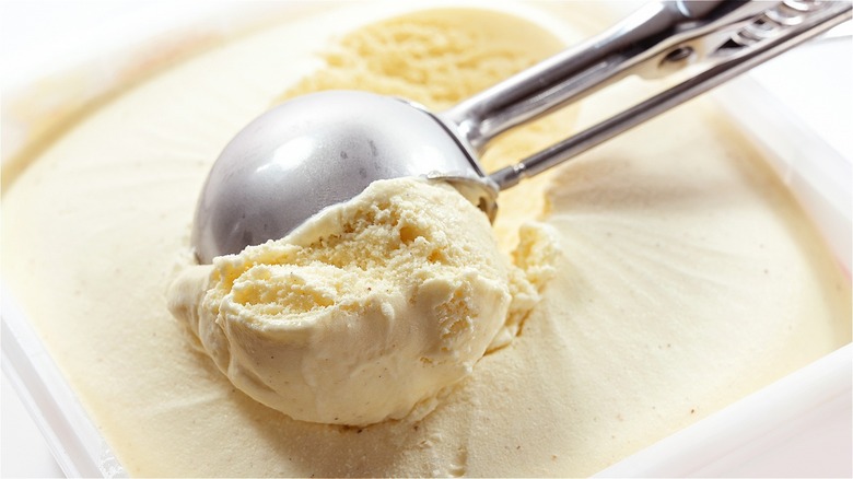 scooping vanilla ice cream