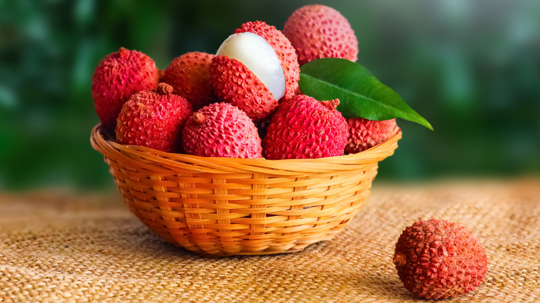 Lychee fruit in a small wicker basket