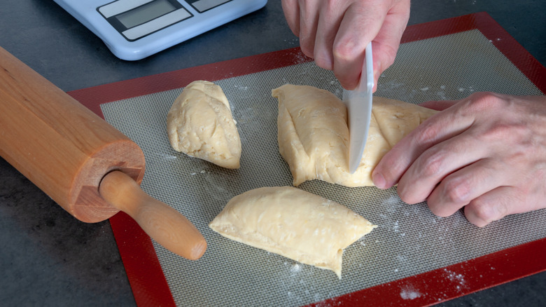 Cutting dough on silicone mat