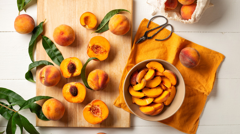 Cutting peaches and pits in kitchen 