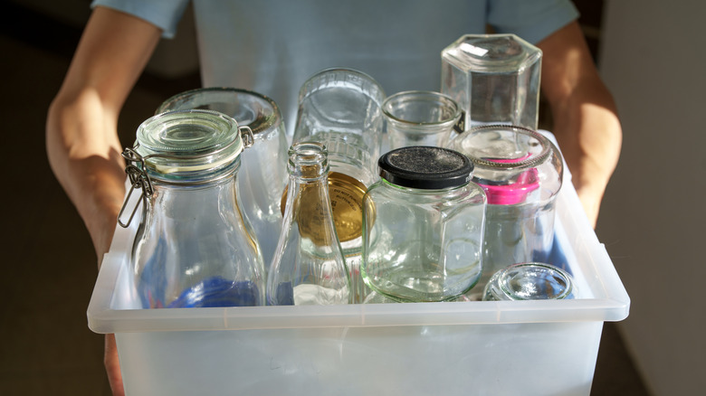 Person holding variety of empty jars