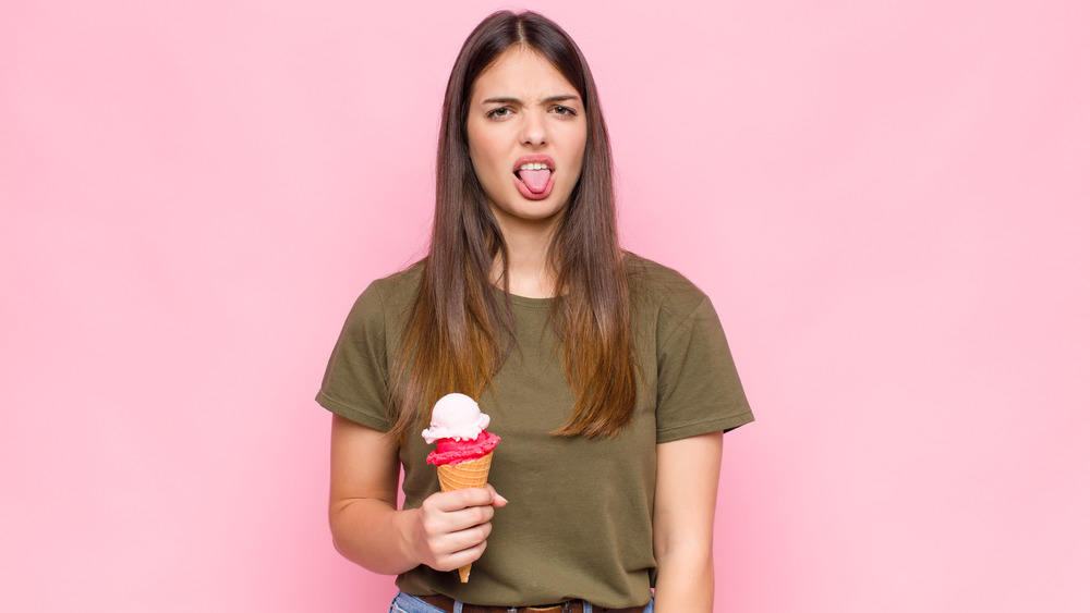 Woman eating bad-tasting ice cream