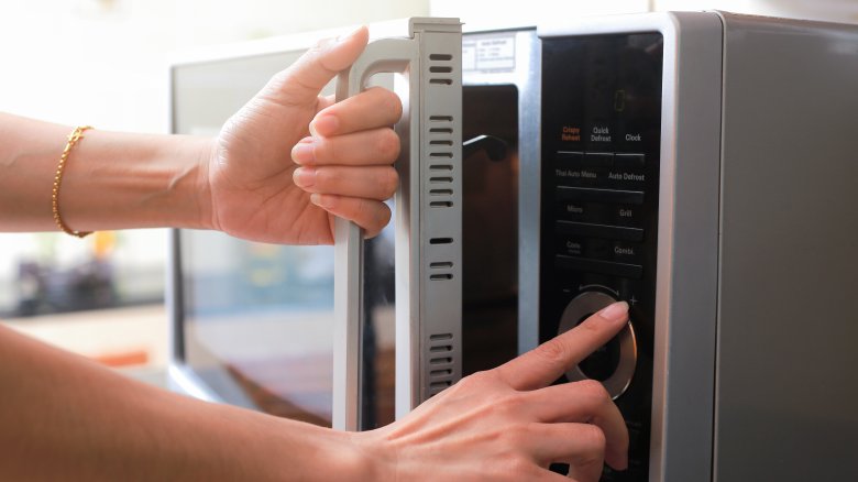 Woman using microwave