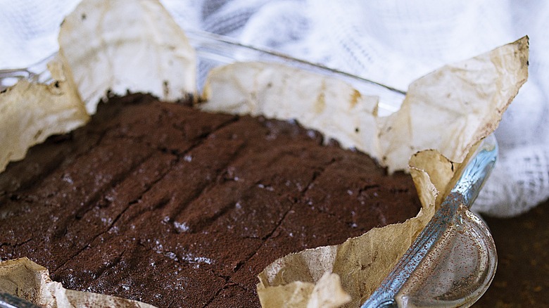 Brownies on parchment in glass pan