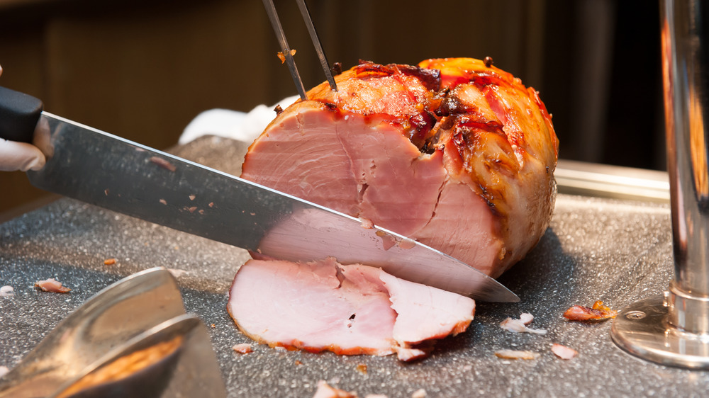 Knife carving boneless ham