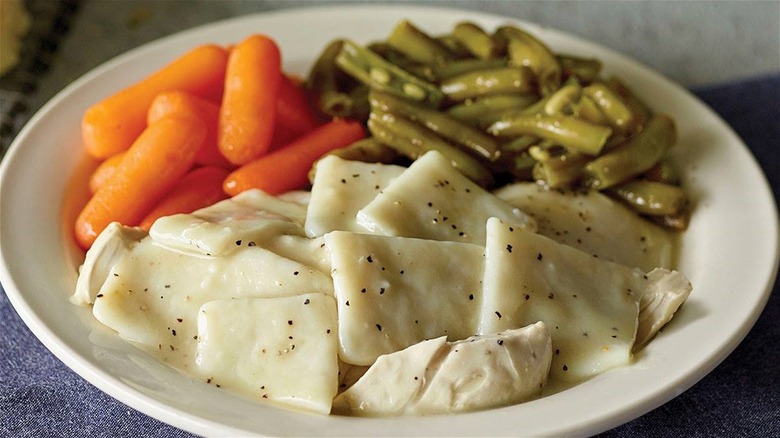 Plate of dumplings with carrots and green beans