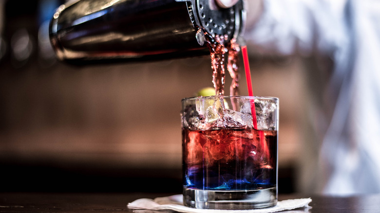 Cocktail being poured into a glass