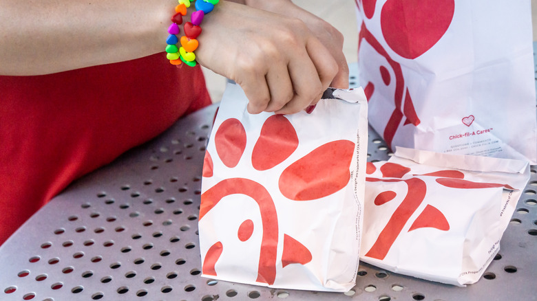 Chick-fil-A patron holding sandwich bag