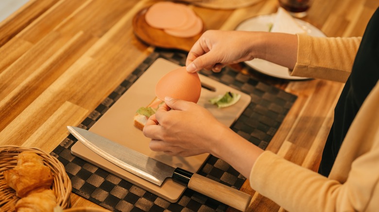 person making sandwich with deli meat