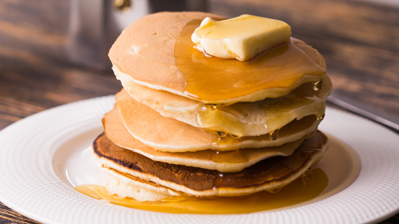 Pancakes covered with syrup and butter