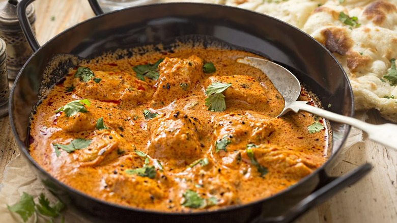 A pan with butter chicken curry