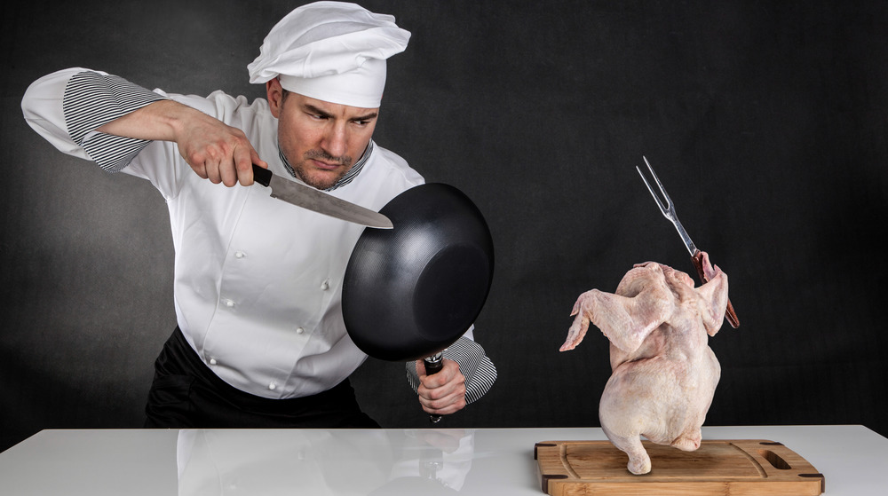 Chef battling raw chicken