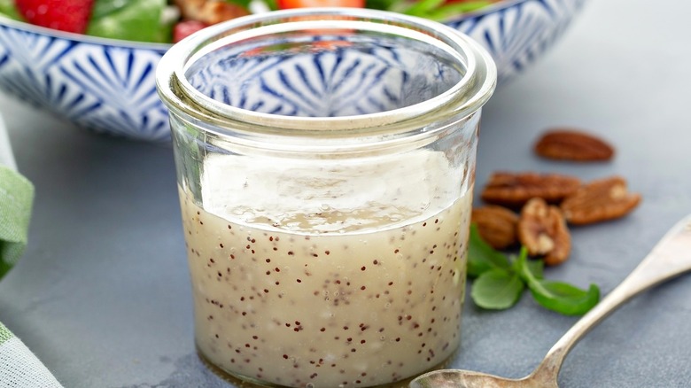 Glass jar of creamy salad dressing