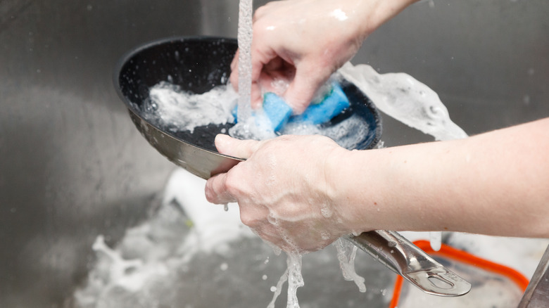 cleaning a pot in sink