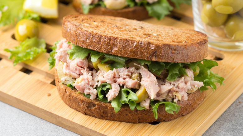 Tuna salad sandwich on a wooden cutting board