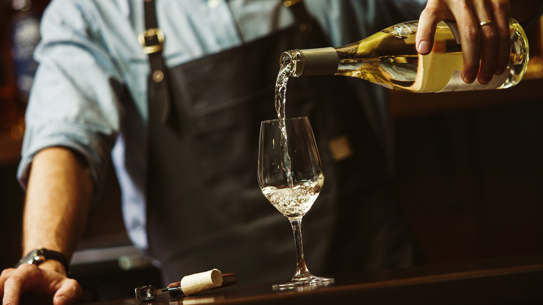 Sommelier pouring white wine