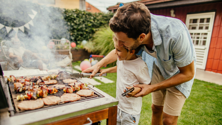 man and boy grilling