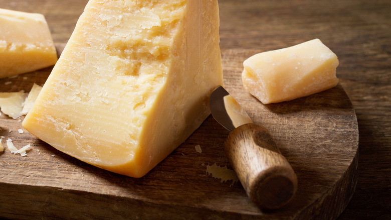 A block of parmesan on a wooden board