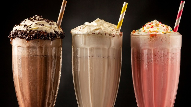 three milkshakes with whipped cream