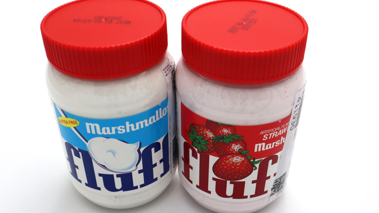 Jars of Marshmallow and Strawberry Marshmallow Fluff on a countertop.