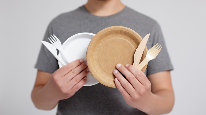 A person holding single use utensils