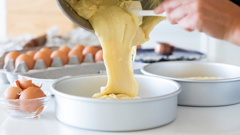 Pouring cake batter into cake pan