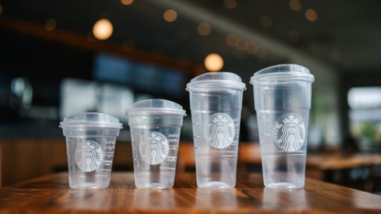 Four plastic Starbucks cups