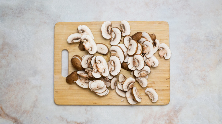 sliced mushrooms on wooden board