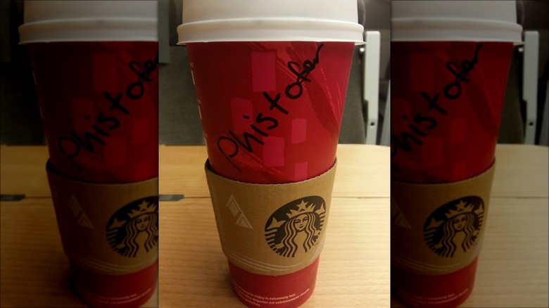 Red Starbucks cup with the name "Christopher" spelled as "Phistofer."