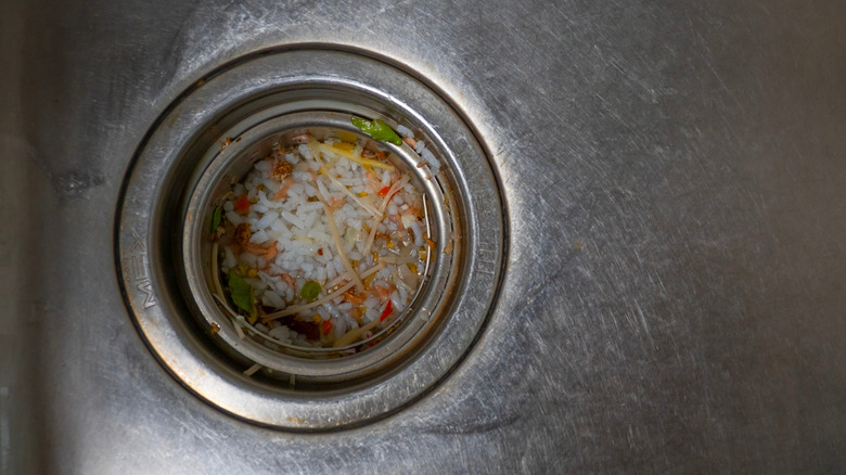Rice and food pieces in sink drain