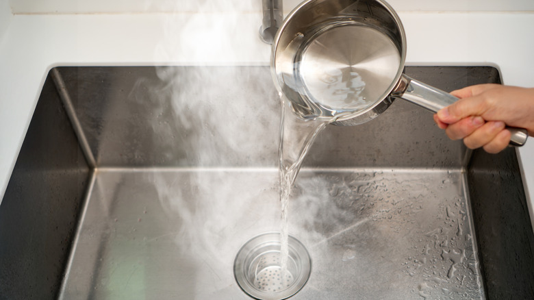 Pouring a pan of boiling water down sink drain