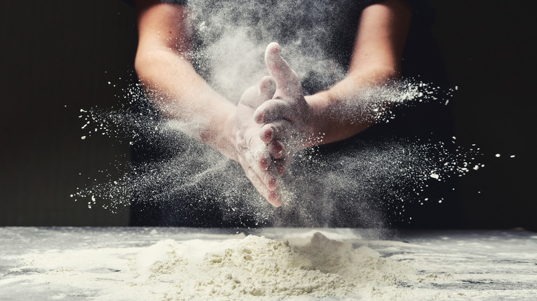 Baker's hands covered in flour