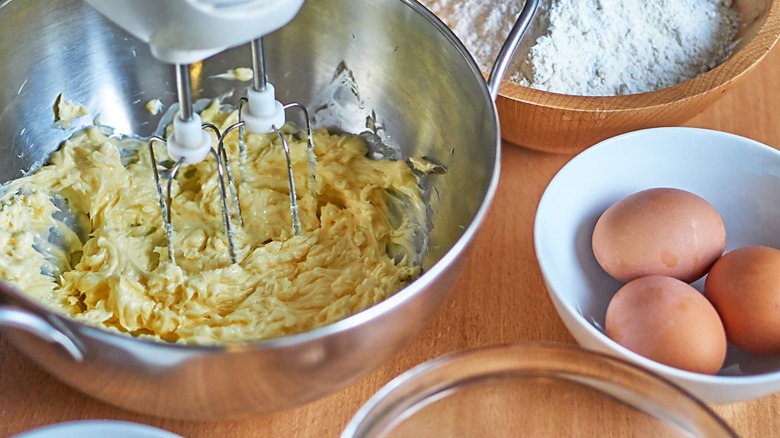 Batter in a mixing bowl with eggs and flour