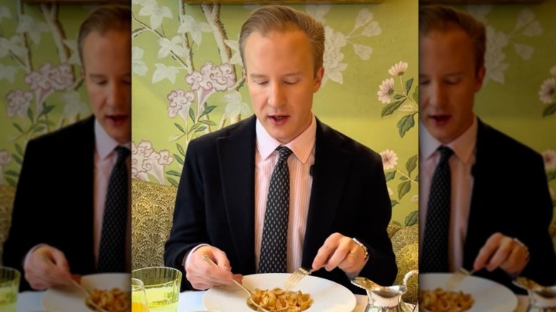 William Hanson eating cornflakes with a fork and spoon