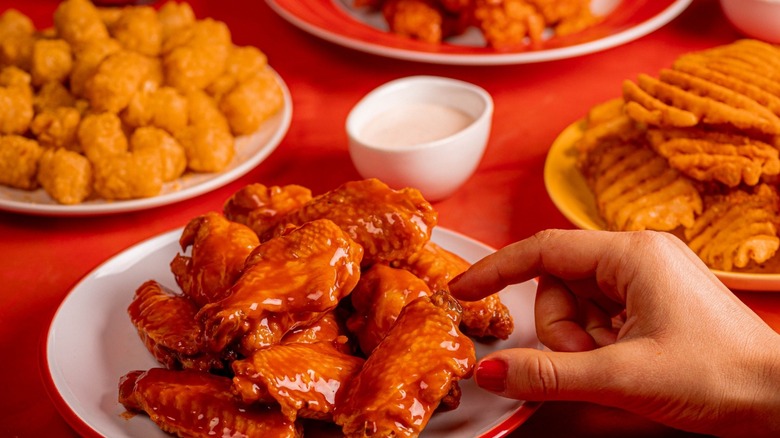 Wings Over chicken wings, waffle fries, and tots